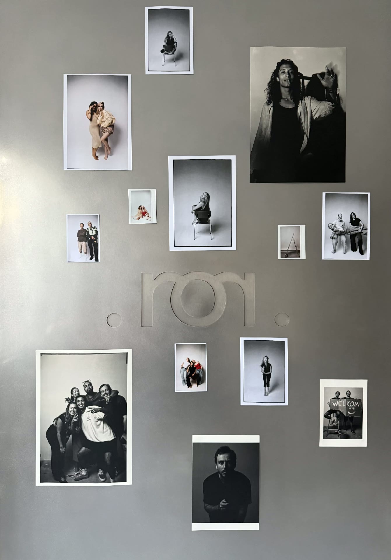 The mirror.ams studio wall covered in guest self-portraits around the studio logo
